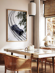 Dark blue vintage streamlined car on snow-covered railway tracks with fir branches in winter, in a styled room mockup