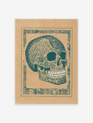 Decorated skull art print with intricate teal patterns on brown paper, framed by an ornate border