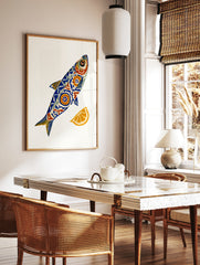 Stylised fish illustration with blue and orange geometric patterns and a lemon slice on a white, in a styled room mockup