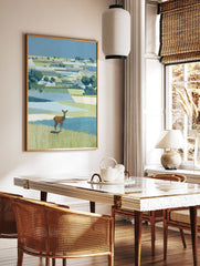 Illustrative landscape wall art featuring a brown deer standing in green and blue patterned fields under a clear blue sky. - Image 2
