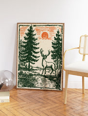 Vintage deer wall art featuring a stag in a green forest with pine trees and an orange sun in a woodcut illustration style. - Image 2