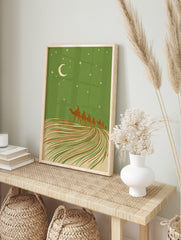 Illustrative desert night scene with camel caravan, crescent moon, and stars against a green, in an alternate framed mockup