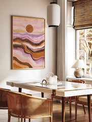 Abstract dot art print of a desert sunset with a large brown sun, pink, purple, and orange wavy, in a styled room mockup
