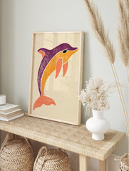 Stylised dolphin illustration in purple, orange, and coral on a neutral background, in an alternate framed mockup