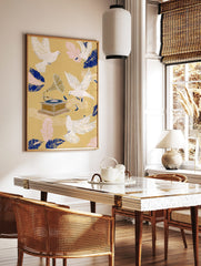 Illustrative art print with white doves flying around a vintage gramophone, blue and pink feathers, in a styled room mockup