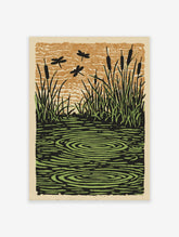 Illustrative print of dragonflies flying over a pond with cattails, grass, and water ripples in green and brown