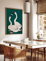 Illustrative print of two white swans on teal background, one drinking from a dark bottle, in a styled room mockup