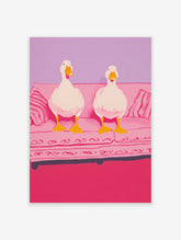 Whimsical illustration of two white ducks with yellow beaks and feet sitting on a pink couch against a purple wall.