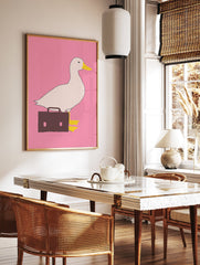 White duck with yellow beak and black eye carrying a brown briefcase on a pink background, quirky duck wall art print. - Image 2