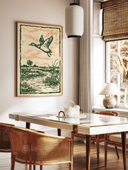 Vintage illustration of a duck flying over a green marshland with an orange sky, framed by a dark green border. - Image 3