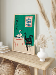 Illustrative art print of a white and black duck at a table with Japanese calligraphy on a, in an alternate framed mockup