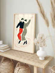 Illustrative print of two dancers in black, red, and cream, in dynamic poses on a plain, in an alternate framed mockup