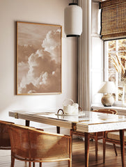 Close-up of voluminous sepia-toned cumulus clouds in a dynamic sky, captured in a photographic style, in a styled room mockup