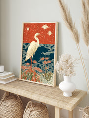 White egret bird standing in red spider lilies with blue water and a starry orange sky. Japanese egret wall art print. - Image 3