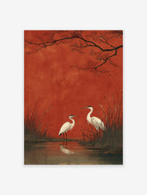 Two white egrets stand in a marsh with tall reeds and water reflections, set against a bold red background with dark tree branches. Japanese style egrets wall art.