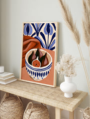 Still life art print of figs in a blue and white patterned bowl with terracotta fabric and, in an alternate framed mockup
