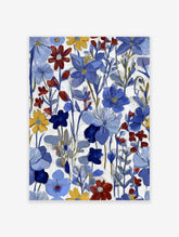 Vibrant floral wall art with blue, red, and yellow painted flowers on a white background.