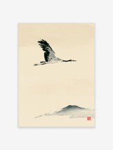 Flying crane in black ink wash above a grey mountain silhouette on cream paper