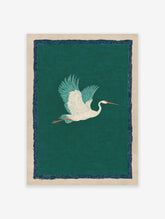 White crane bird with teal wings flying against a deep green wave-patterned background, with a navy border