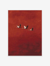 Three cranes with outstretched wings flying diagonally against a textured red background