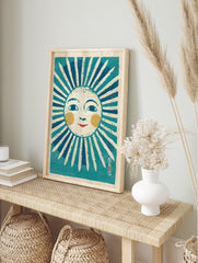 Stylized folk art sun print illustration with a smiling face, blue rays, yellow cheeks, and red lips on textured paper. - Image 3