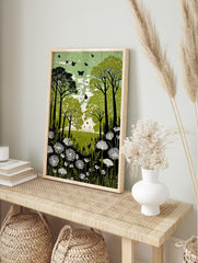 Green forest meadow print with dark trees, white flowers, and black butterflies in a linocut, in an alternate framed mockup