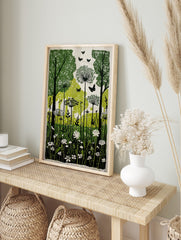Green and black linocut style print of a forest with trees, tall wildflowers, and butterflies, in an alternate framed mockup