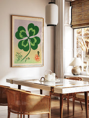 Four-leaf clover botanical illustration in Japanese style with calligraphy, red seal, and floral, in a styled room mockup