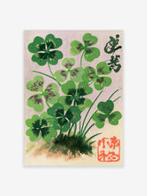 Botanical illustration of four-leaf clovers with Japanese calligraphy and a red seal stamp on a soft lavender background