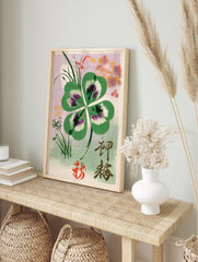 Four-leaf clover botanical illustration with Japanese kanji and red seal on a lilac background, in an alternate framed mockup