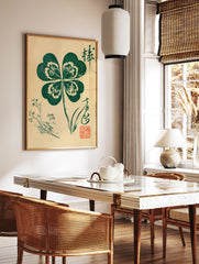 Botanical four-leaf clover art print with Japanese calligraphy and red seal stamp on cream paper, in a styled room mockup
