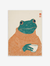 Whimsical frog art print featuring a green frog wearing an orange turtleneck sweater and holding a white cup on an off-white background.