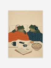 Illustration of two green frogs in bed with headphones, blankets, popcorn, and a book. Cozy frog art print.