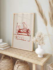 Reddish-brown illustration of a frog on a turntable with a wine bottle, glass, and Japanese, in an alternate framed mockup