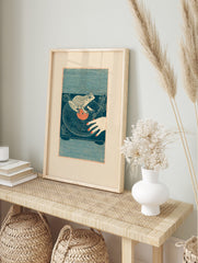 Illustrative frog DJ wall art on a turntable with a vinyl record and human hand, in an alternate framed mockup