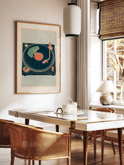 Illustrative green frog on a deep teal vinyl record and turntable art print with reddish-orange, in a styled room mockup