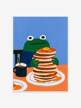 Illustration of a green frog sitting at an orange table eating a large stack of pancakes, blue wall background