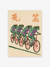 Four green frogs in sunglasses riding a red tandem bicycle on a beige background with orange characters