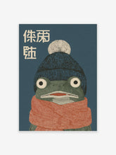 Illustrative frog wall art wearing a blue beanie and orange scarf with Japanese text on a dark blue background, cozy animal print.