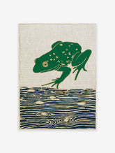 Green frog leaping over blue water on a woven tapestry with gold outlines