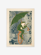 Whimsical green frog wall art print riding a unicycle and holding an umbrella against a striped blue and white background.