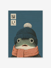 Whimsical frog wall art illustration wearing a blue beanie and orange scarf with Japanese text on a blue background.