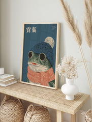 Whimsical frog wall art illustration with a frog wearing a blue beanie, white pom-pom, and orange striped scarf. - Image 3