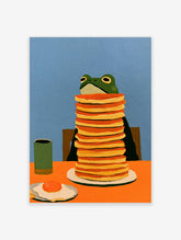 Green frog sitting with a tall stack of pancakes, a fried egg, and a mug on an orange table against a blue wall