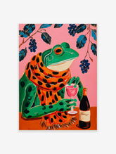 Illustrative wall art of a green frog in a polka-dot scarf, holding a wine glass on a pink background