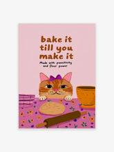 Ginger cat in purple bow with paws on table beside dough and rolling pin, pink baking poster