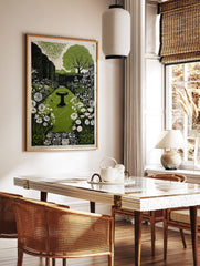 Illustrative garden print with central bird bath, green path, white flowers, and hedgerows, in a styled room mockup