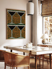 Geometric pattern wall art with orange speckled shapes on dark green, black triangles, and white, in a styled room mockup