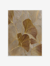 Abstract gold botanical wall art with textured ginkgo leaves and metallic accents on a neutral background.