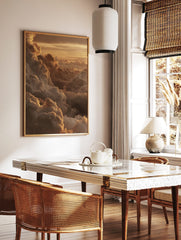 Golden cumulus clouds at sunset, with light catching the edges of the atmospheric sky print, in a styled room mockup